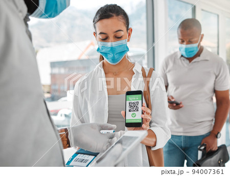 Covid passport, QR code or travel with security scanning a woman in airport arrival or departure lounge. Safety, immigration and refugee status with control of people during the corona virus pandemic 94007361