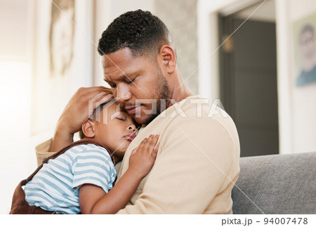 Sleeping and tired child with caring father holding his sleepy son on a home lounge sofa. Worried dad hugging his young boy resting on a living room family couch indoors feeling stress and worry Sleeping and tired child with caring father holding his sleepy son on a home lounge sofa. Worried dad hugging his young boy resting on a living room family couch indoors feeling stress and worry 94007478