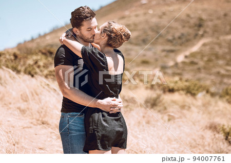 Kissing, relaxed and romantic couple enjoying love, bonding and break on getaway together on a sunny day outdoors. Boyfriend and girlfriend in a loving relationship on honeymoon, holiday and date Kissing, relaxed and romantic couple enjoying love, bonding and break on getaway together on a sunny day outdoors. Boyfriend and girlfriend in a loving relationship on honeymoon, holiday and date 94007761