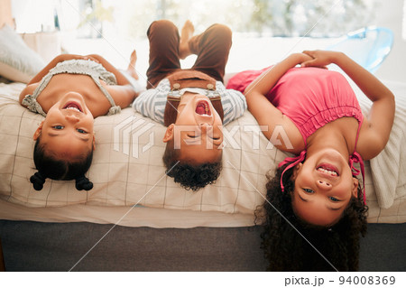 Silly kids playing upside down on bed enjoy and having fun together in parents bedroom. Happy children or siblings bonding and enjoying childhood together at cozy, warm and comfortable family home Silly kids playing upside down on bed enjoy and having fun together in parents bedroom. Happy children or siblings bonding and enjoying childhood together at cozy, warm and comfortable family home 94008369