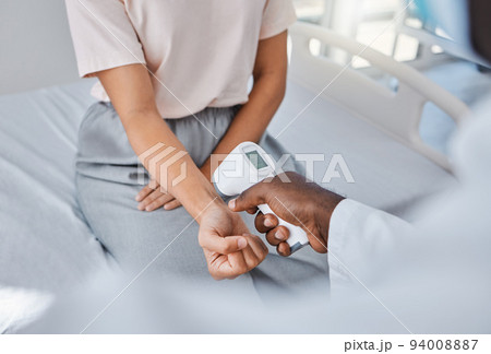 Doctor check temperature of sick covid patient to test fever, risk of disease or flu. Healthcare worker hands scanning with laser thermometer for virus safety and clinic service in medical hospital Doctor check temperature of sick covid patient to test fever, risk of disease or flu. Healthcare worker hands scanning with laser thermometer for virus safety and clinic service in medical hospital 94008887