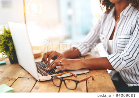 Closeup of hands typing, writing or replying on laptop while browsing or searching startup business ideas in a cafe. Creative entrepreneur, remote blogger or student with an online blog in restaurant 94009081