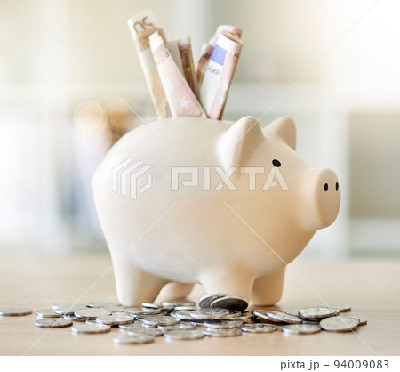 .Finance, money and savings in a piggy bank of cash for growth, investment and retirement wealth. Coins and paper currency for banking, accounting and income while planning a strategy for the future. 94009083