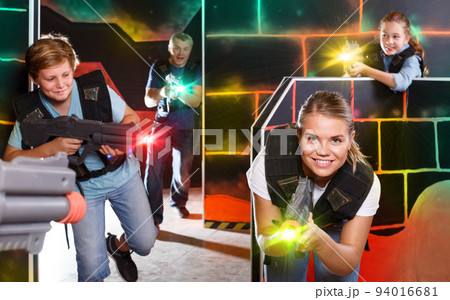vigorous teen boy having fun on laser tag arena with his older s vigorous teen boy having fun on laser tag arena with his older s 94016681