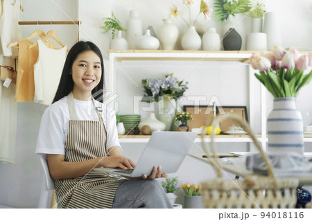 business owner smiling happily looking at the camera with be happy when reading news online. business owner smiling happily looking at the camera with be happy when reading news online. 94018116