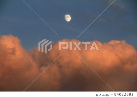 秋の夕暮れ　夕日に染まる雲と月 94022693
