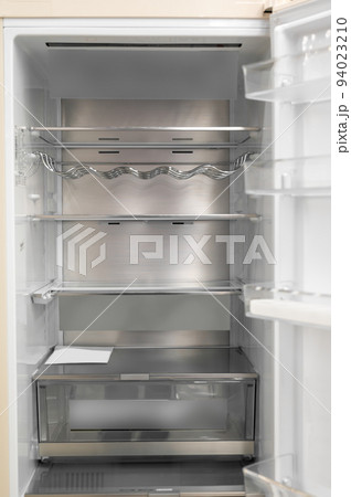 Opened empty refrigerator. Refrigerator open empty fridge inside interior. close up on empty fridge with door open. New clean refrigerator. Opened empty refrigerator. Refrigerator open empty fridge inside interior. close up on empty fridge with door open. New clean refrigerator. 94023210