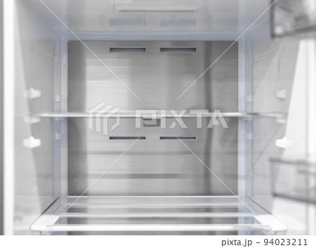 Opened empty refrigerator. Refrigerator open empty fridge inside interior. close up on empty refrigerator with door open. New clean refrigerator. Opened empty refrigerator. Refrigerator open empty fridge inside interior. close up on empty refrigerator with door open. New clean refrigerator. 94023211