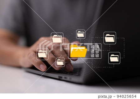 E-documents enable paperless offices. A businessman types on a laptop while examining virtual document icons. E-documents enable paperless offices. A businessman types on a laptop while examining virtual document icons. 94025654