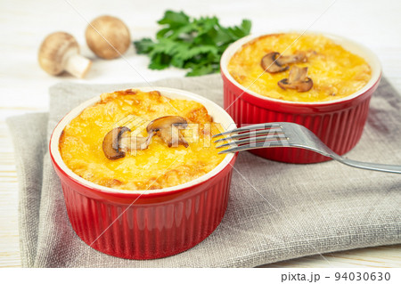 French Julienne casserole with chicken and mushroom in portion ramekin on white background French Julienne casserole with chicken and mushroom in portion ramekin on white background 94030630