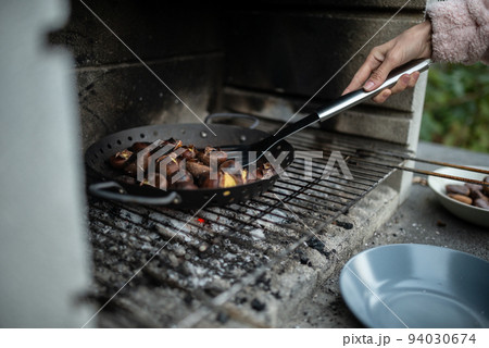 Closeup view of a woman roasting delicious chestnuts 94030674