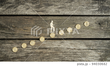 Man climbing a staircase of Bitcoins Man climbing a staircase of Bitcoins 94030682