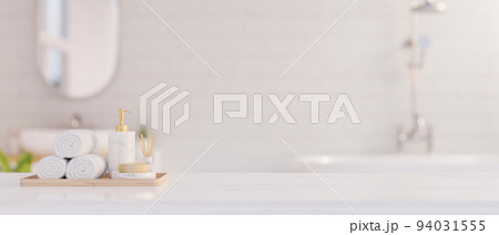 Elegance white marble bathroom tabletop with copy space for product display over blurred bathroom Elegance white marble bathroom tabletop with copy space for product display over blurred bathroom 94031555