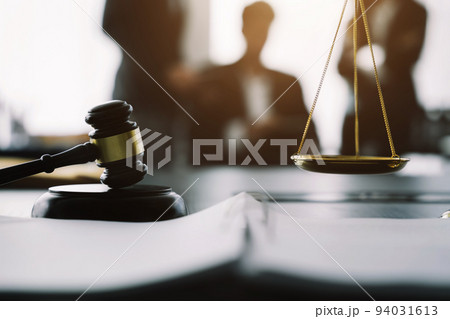 Close up view of auction hammer on the desk in lawyer office, Business people and lawyers discussing contract papers sitting in the table at office. Close up view of auction hammer on the desk in lawyer office, Business people and lawyers discussing contract papers sitting in the table at office. 94031613
