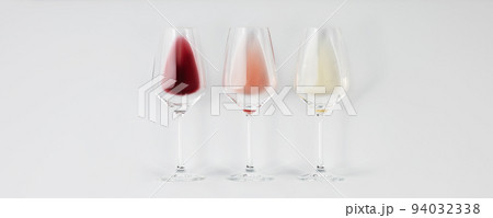 Flat-lay of red, rose and white wine in glasses on white background, banner 94032338