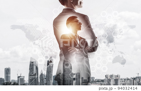Concept of business success and control with confident boss against cityscape background Concept of business success and control with confident boss against cityscape background 94032414
