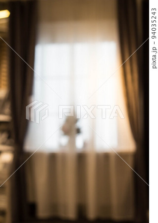 Abstract and blurry image of window with curtains with fir tree 94035243