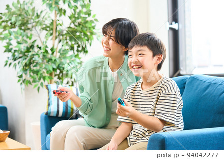 ソファーに座りゲームをする親子　母親と息子 94042277