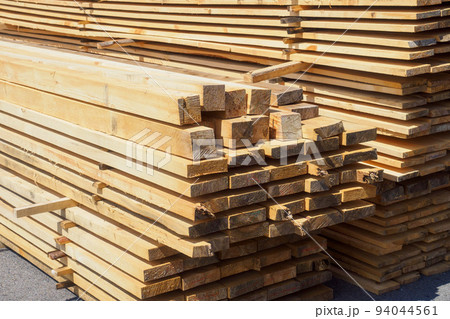 Wooden boards are stacked in a sawmill or carpentry shop. Sawing drying and marketing of wood 94044561