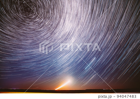 Moonrise Sky Natural Background. Unusual Amazing Stars Effect In Sky. Trace Of Moon. Spin Of Star And Meteoric Trails On Night Sky. Large Exposure. Imagination, Fantasy, Illusion, Dream View. Flight 94047483