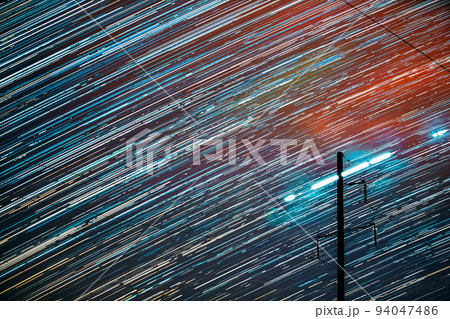 Unusual Amazing Effects In Sky. Bright Night Starry Sky Background. Trails Of Stars Rotate Above Power Line. Large Exposure. Imagination, Fantasy, Illusion, Dream View. Flight Of Fancy 94047486