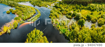 Aerial view. Green forest, meadow and river marsh landscape in summer. Top view of european nature from high attitude in summertime. Bird's eye view. Belarus 94047490