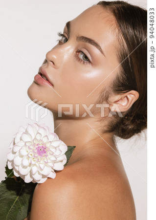 Closeup portrait of beautiful young girl with clean well-kept skin isolated over white background. Skin care. Facial treatment. Cosmetology, beauty and spa. 94048033