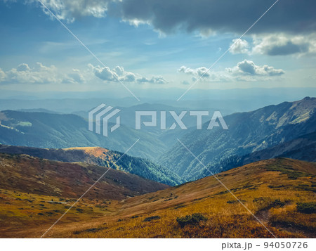 Mountain valley canyon landscape under blue sky. Wonderful autumn scene with orange grass. Beautiful nature background. Vintage retro tone. Travel, hiking, climbing, tourism. Carpathian mountains Mountain valley canyon landscape under blue sky. Wonderful autumn scene with orange grass. Beautiful nature background. Vintage retro tone. Travel, hiking, climbing, tourism. Carpathian mountains 94050726