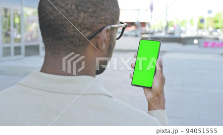 African Man Using Smartphone with Green Screen Outdoor 94051555