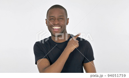 Young African Man Pointing on Side on White Background Young African Man Pointing on Side on White Background 94051759