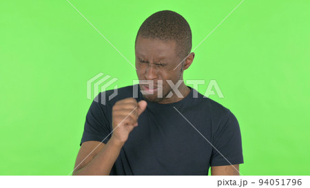 Coughing Young African Man Feeling unwell on Green Background Coughing Young African Man Feeling unwell on Green Background 94051796