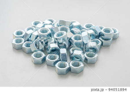 Lots of metal nuts. Nut is a type of fastener with a threaded hole. 94051894