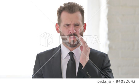 Sick Middle Aged Businessman having Toothache Sick Middle Aged Businessman having Toothache 94052642