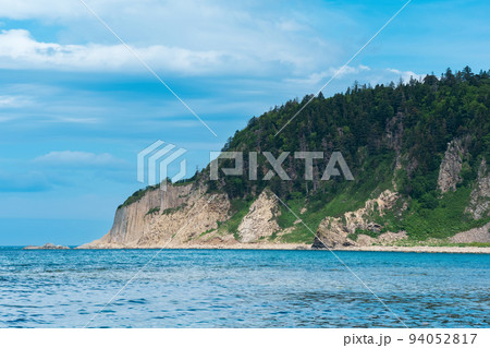 coastal seascape, beautiful lava rocks on the wooded coast of Kunashir island near Cape Stolbchaty 94052817