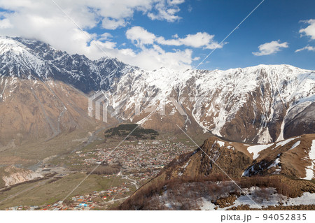 Aerial view of Stepantsminda townlet on a sunny day Aerial view of Stepantsminda townlet on a sunny day 94052835