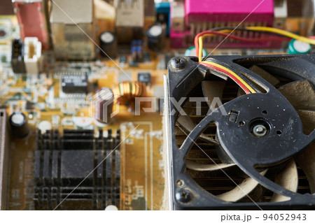 Old motherboard covered in dust and dirt. Close-up. 94052943
