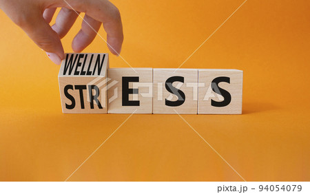 Wellness and Stress symbol. Businessman hand. Turned Wooden cubes with word Wellness and Stress. Beautiful orange background. Business and Wellness and Stress concept. Copy space. Wellness and Stress symbol. Businessman hand. Turned Wooden cubes with word Wellness and Stress. Beautiful orange background. Business and Wellness and Stress concept. Copy space. 94054079