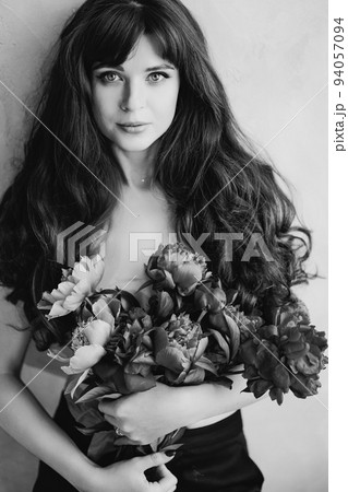 a beautiful woman topless with long hair and a bouquet of peonies. beauty. a beautiful woman topless with long hair and a bouquet of peonies. beauty. 94057094