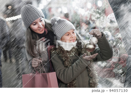 Smiling girl with woman are buying toys for X-mas tree 94057130