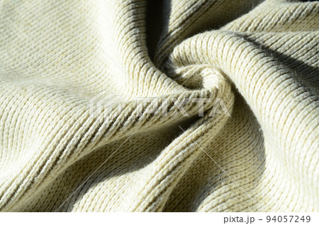 Fabric texture of a soft yellow knitted sweater. Macro image of the structure of bindings in yarns 94057249
