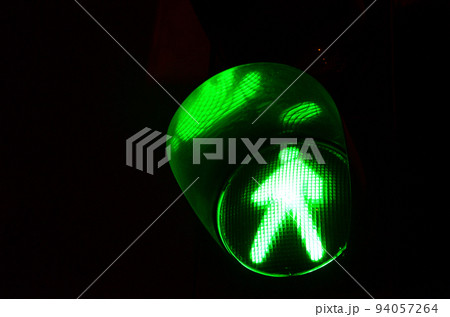 Night photo of a traffic light for pedestrians, which lights up in green Night photo of a traffic light for pedestrians, which lights up in green 94057264