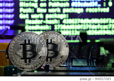 The digital process of cryptocurrency mining by using the GPUs. Bitcoins and video card on a working display and mining screen The digital process of cryptocurrency mining by using the GPUs. Bitcoins and video card on a working display and mining screen 94057265