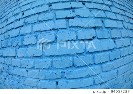 Large brick wall, painted in blue. Fisheye photo with pronounced distortion 94057287