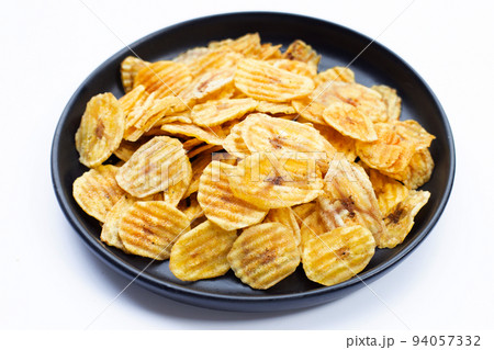Banana slice chips on white background. Banana slice chips on white background. 94057332