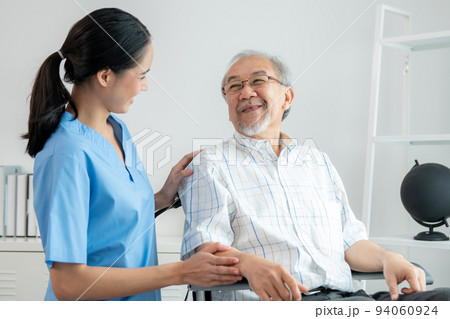 Happy positive asian nurse giving support and touching contented senior man. Happy positive asian nurse giving support and touching contented senior man. 94060924