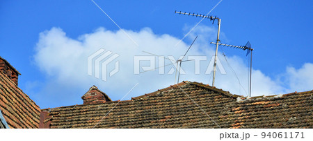 Fragment of the roof of an old high-rise building with roofing of natural roof tiles 94061171