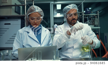 Two scientist in professional uniform working in laboratory 94061685