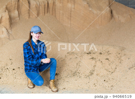Woman farmer checking quality of soybean husk 94066519