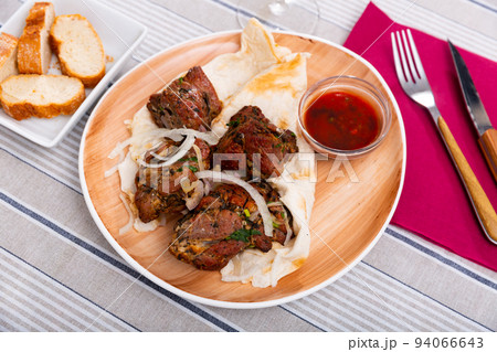 Grilled pork meat shashlik with marinated onion Grilled pork meat shashlik with marinated onion 94066643