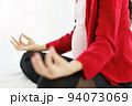 Pregnant woman sits in bed in her bedroom meditating alone in peace and happiness. The new mother resting by sitting down to chill out. 94073069